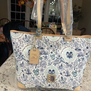 Dooney & Bourke Disney’s DVC 25th Anniversary Blue and White Patterned Tote.